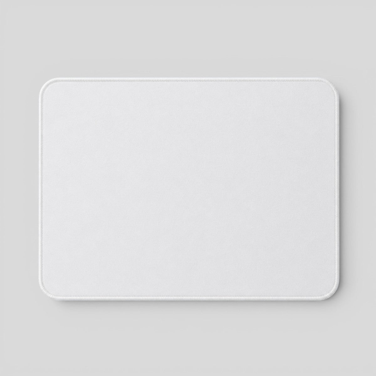 Stockka white fabric mouse pad with rounded corners and stitched edges, ideal for smooth mouse movement.