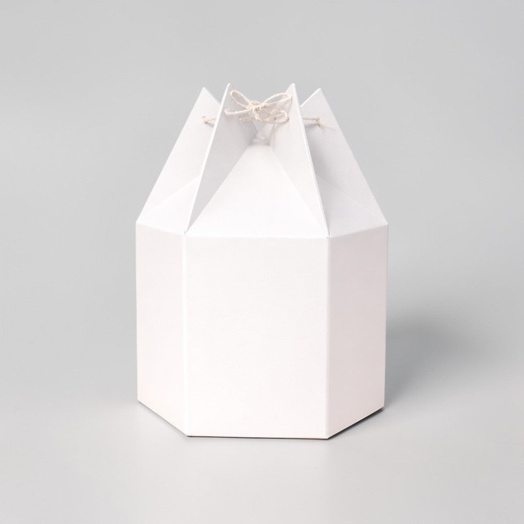 Stockka white hexagonal paper gift box with unique string closure, origami style. Perfect for festive packaging.