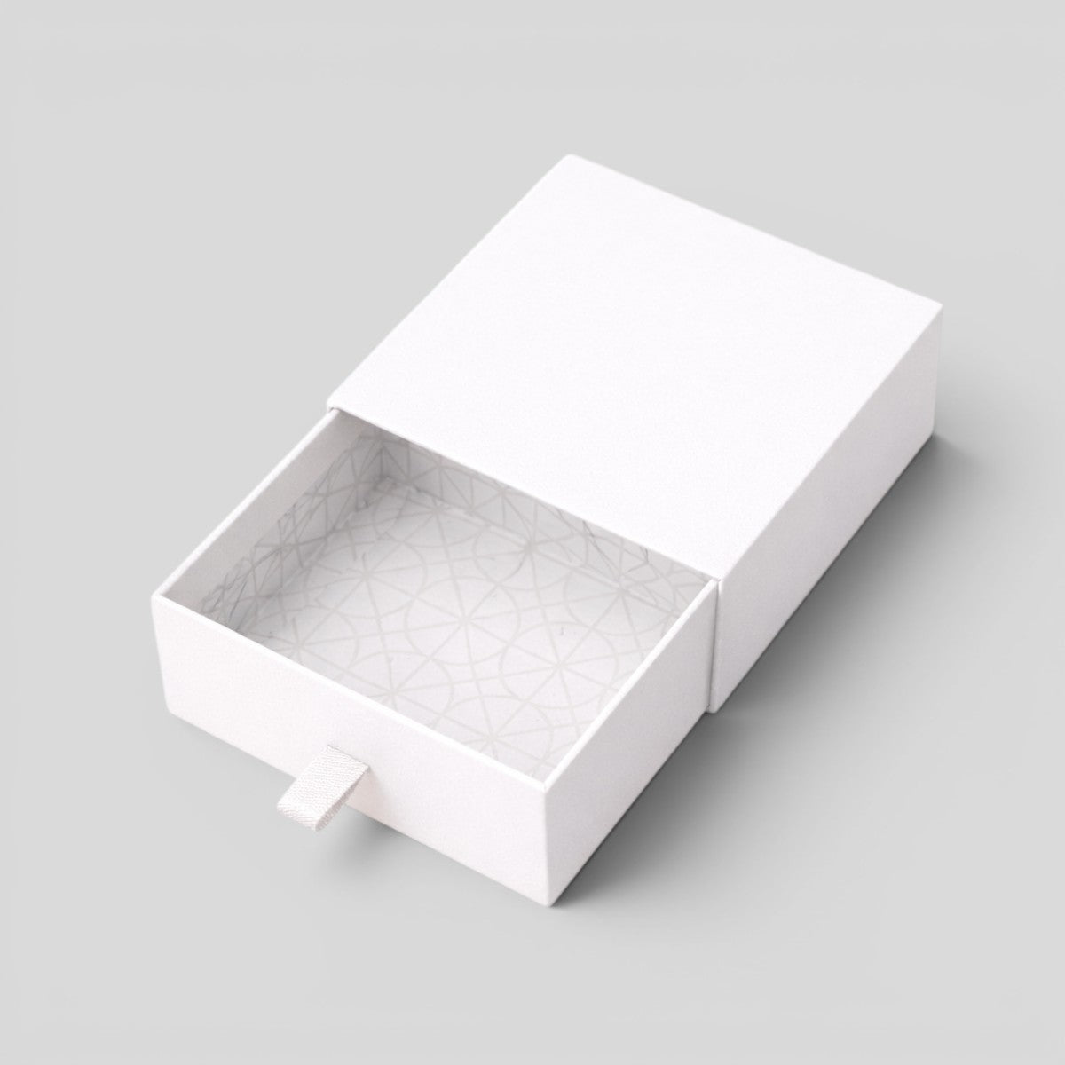 Stockka white rigid cardboard jewelry box with drawer and fabric pull tab, geometric pattern interior.