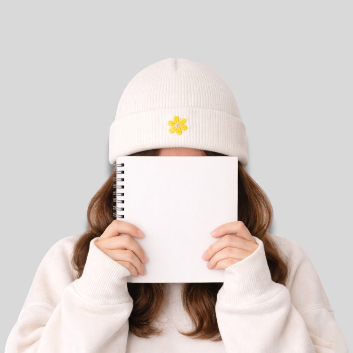 Stockka white acrylic knit beanie with yellow flower embroidery. Unisex winter hat.