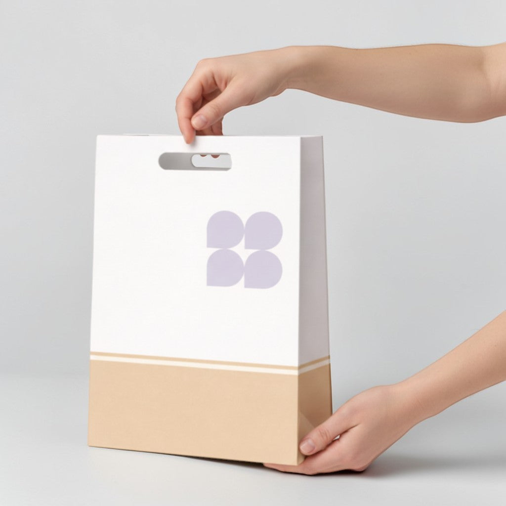 Stockka white kraft paper retail bag with cut-out handles and a beige bottom section.
