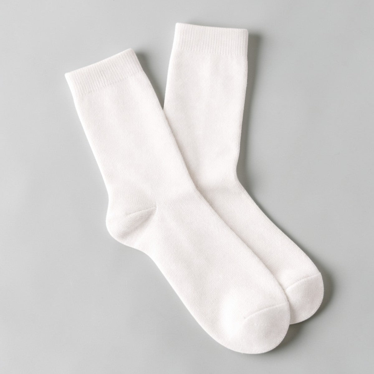 Stockka white mid-calf socks made of cotton and spandex, offering comfort and breathability for casual wear.