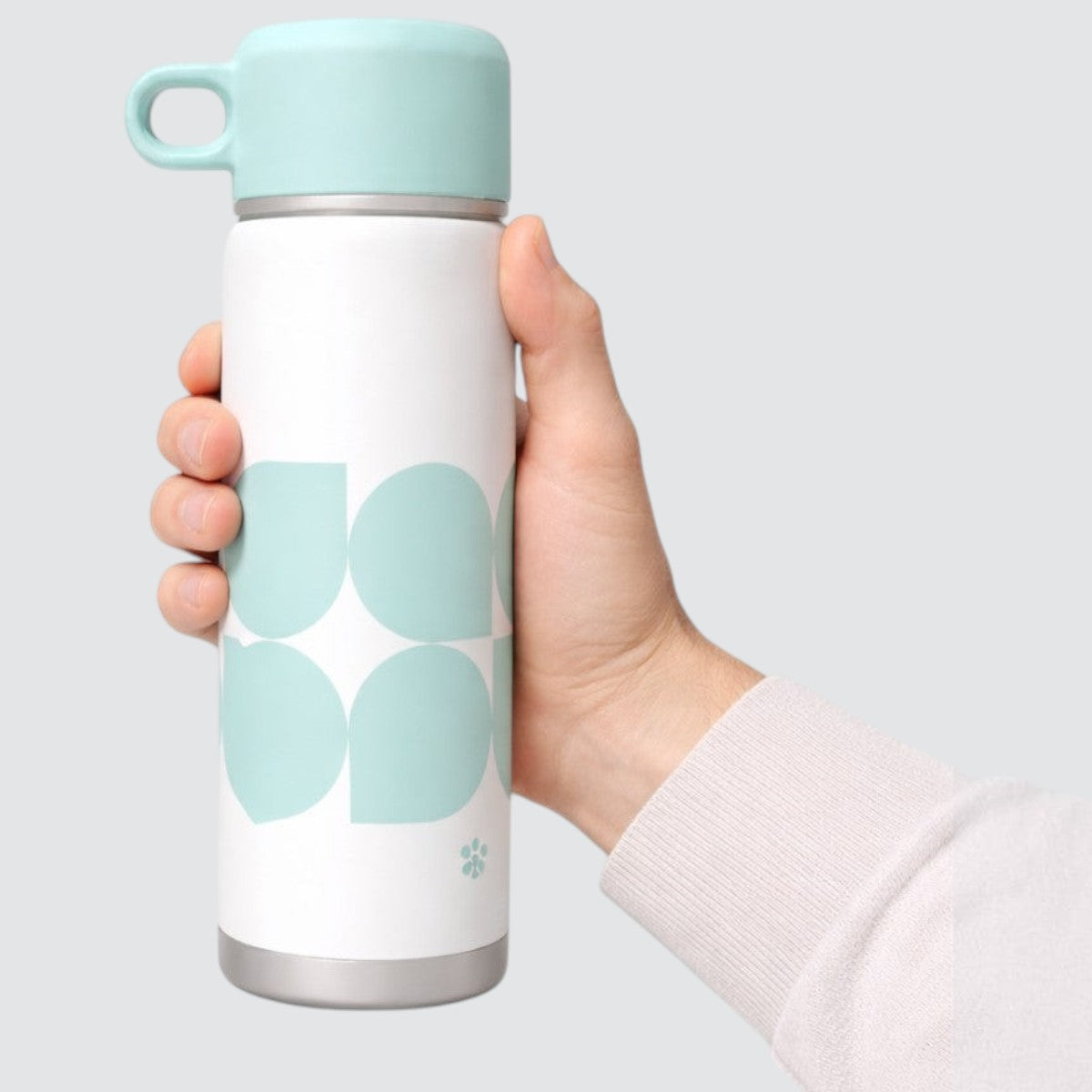 Stockka white stainless steel thermal bottle with mint green abstract pattern and carrying loop lid.