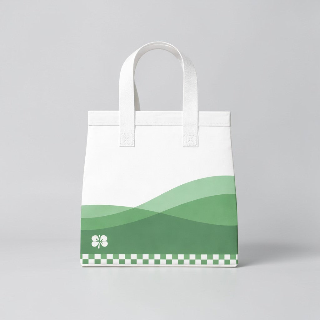Stockka medium white non-woven polypropylene tote bag with green wavy design and clover detail.