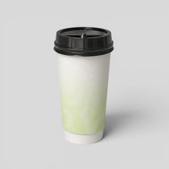 Stockka white paper coffee cup with a black lid, featuring a subtle green swirl pattern. Ideal for hot beverages.
