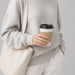Stockka white paper coffee cup with corrugated kraft sleeve and black lid, perfect for takeaway.