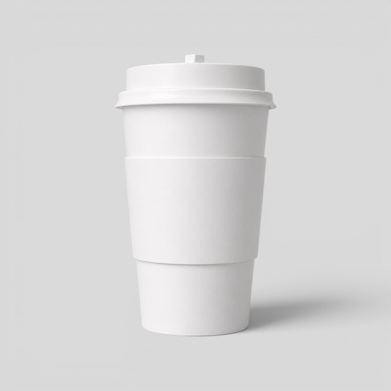 Stockka 473ml double-walled white paper coffee cup with insulating sleeve and black lid.