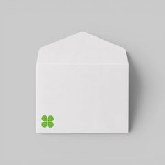 Stockka classic white 120gsm paper envelope with triangular flap and small green clover logo