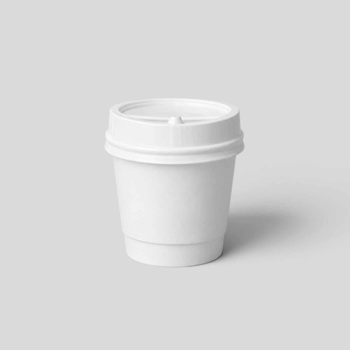 Stockka small white paper espresso cup with a black plastic lid, ideal for events.