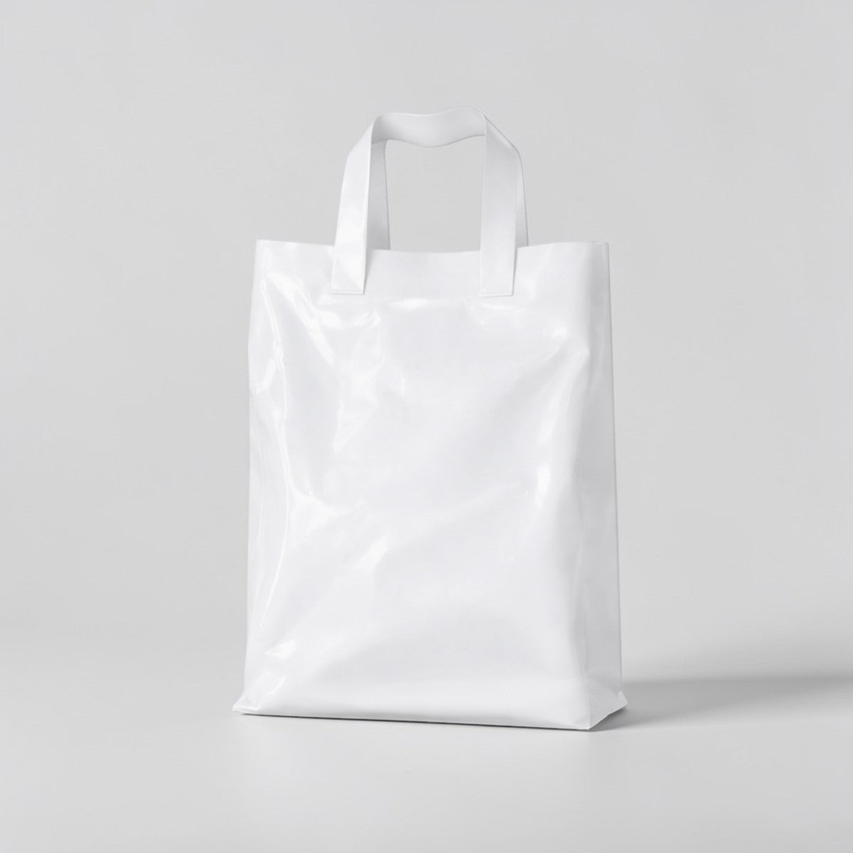 Stockka white plastic shopping bag with soft loop handles, 30x40cm, made from HDPE.
