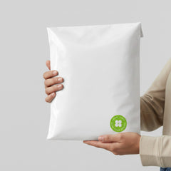 Stockka white poly mailer bag with a green "Thank You For Your Order" sticker and a clover design.