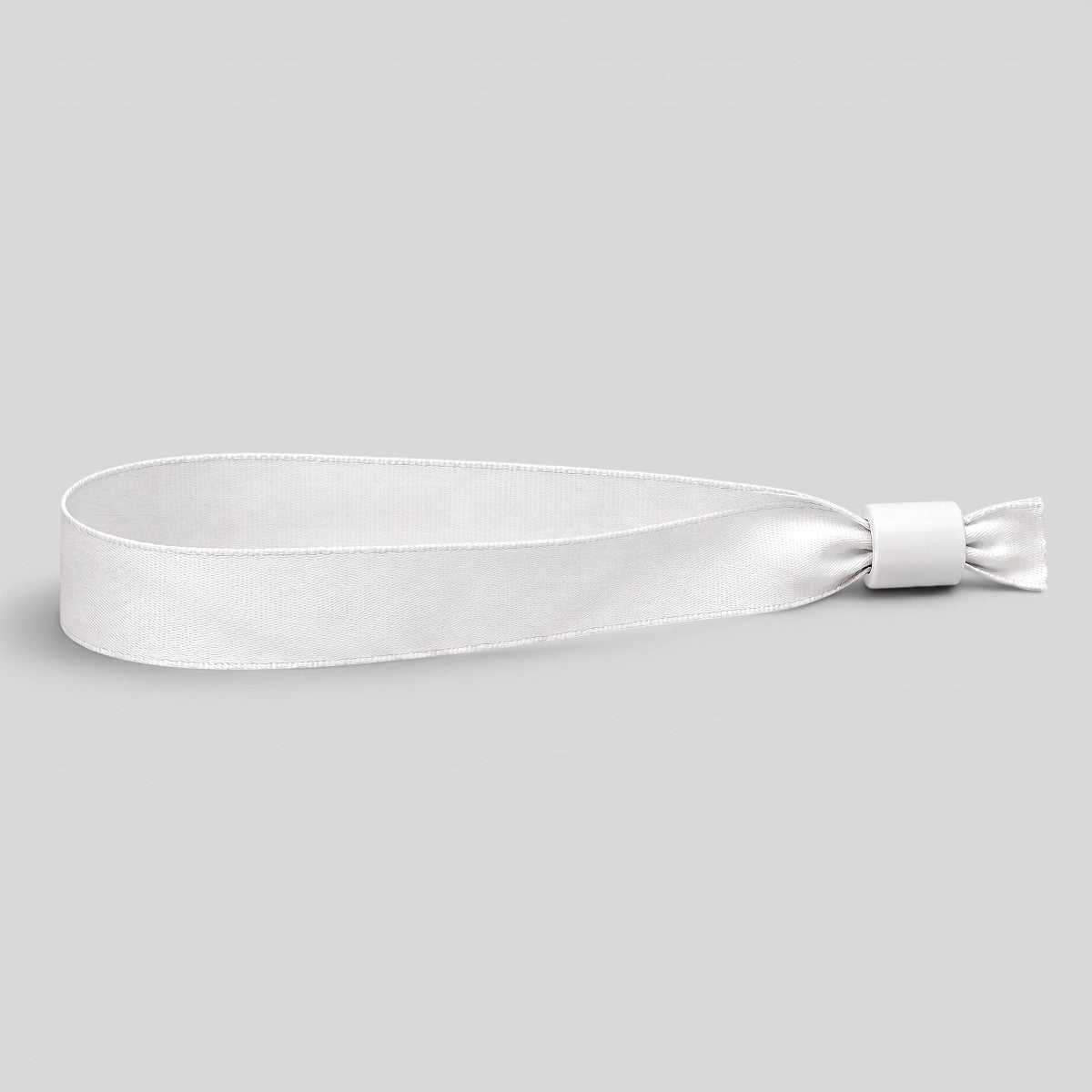 Stockka white polyester wristband with adjustable plastic closure, ideal for events and festivals.