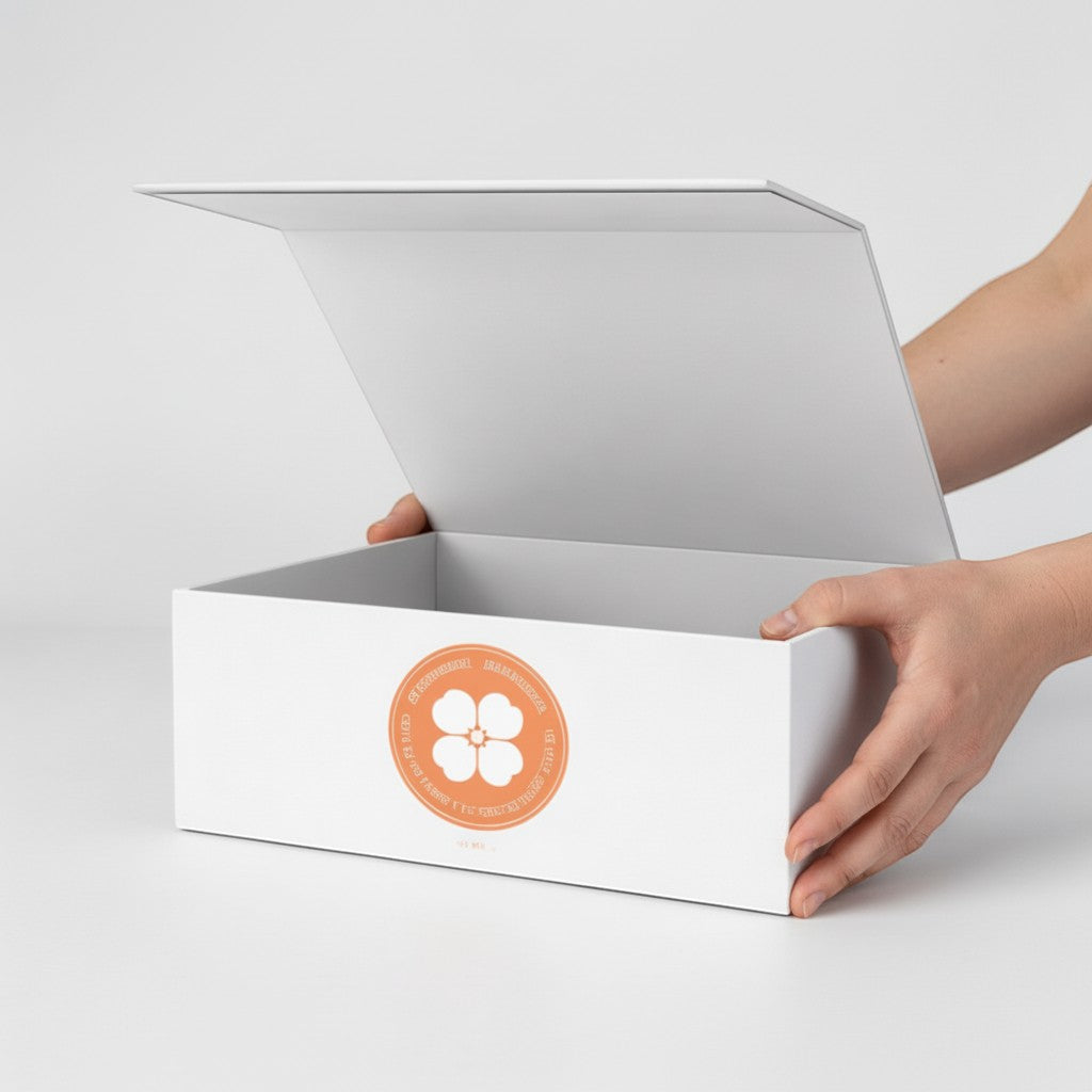Stockka minimalist white rigid cardboard gift box with attached lid and orange clover logo. Ideal for luxury items.