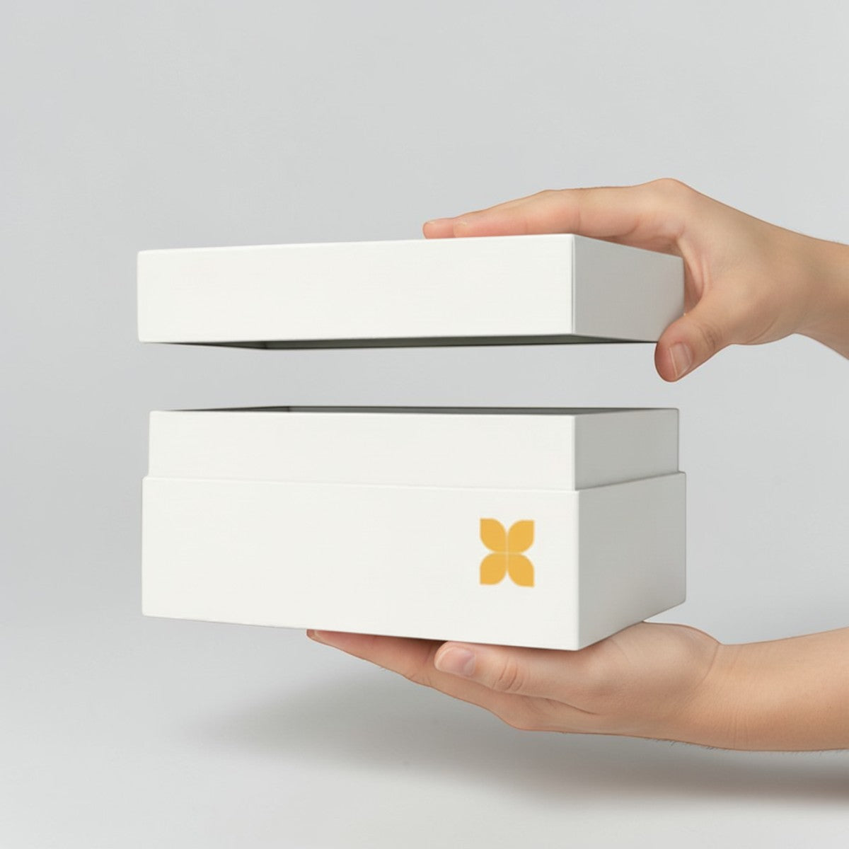 Stockka white rigid box with removable lid and gold flower logo, ideal for luxury gifts and jewelry.