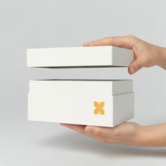 Stockka white rigid box with removable lid and gold flower logo, ideal for luxury gifts and jewelry.