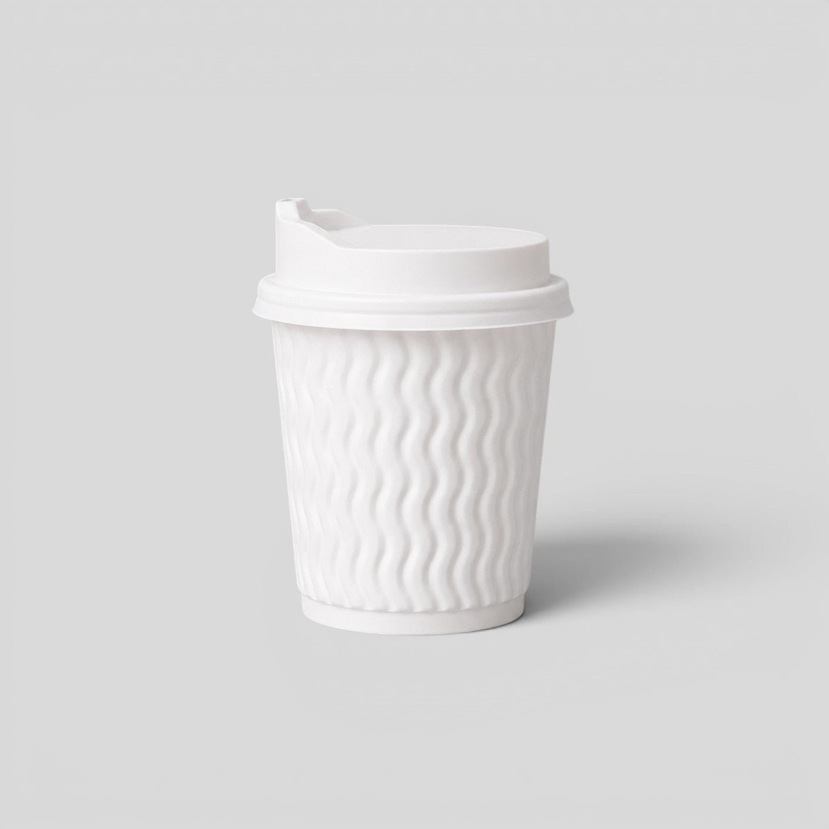 Stockka small white ripple paper cup with a white lid, perfect for espresso or macchiato.