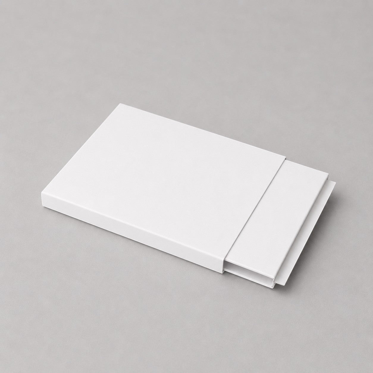 Stockka white matte cardboard slider box packaging, ideal for gift vouchers, luxury tickets, or premium promotional items.