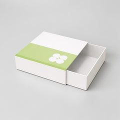 Stockka white rigid square gift box with green accent and white flower design, drawer style opening.
