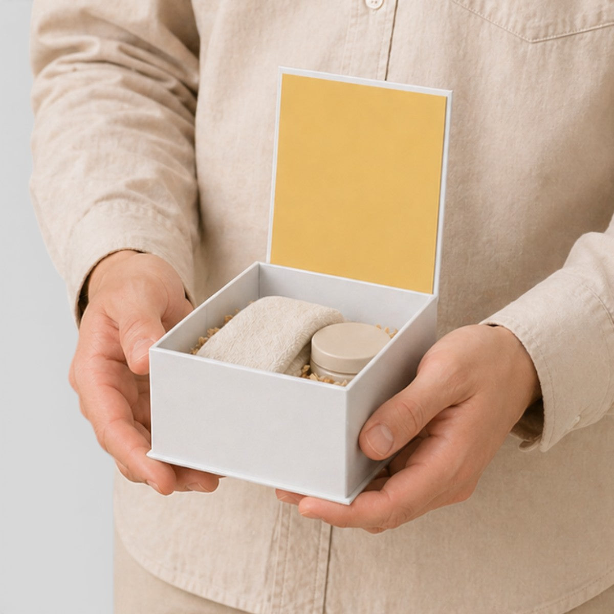 Stockka white square magnetic gift box with yellow interior, holding small items. Perfect for luxury packaging.