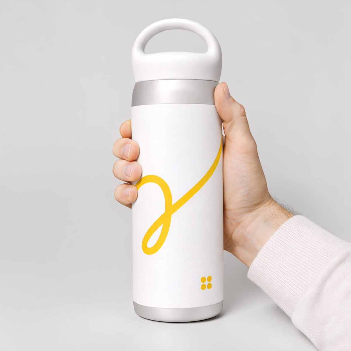 Stockka white stainless steel thermal water bottle with yellow swirl design and top handle. Double-walled for insulation.