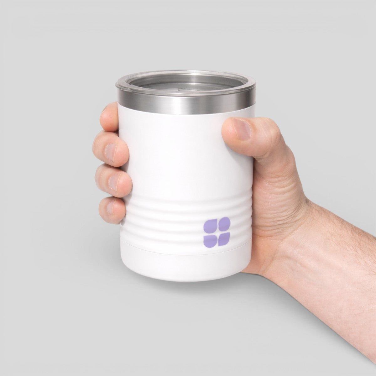 Stockka white stainless steel thermal wine tumbler with lid and grooved base, held by hand.