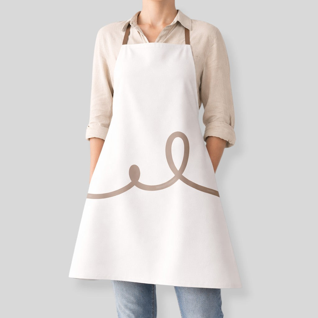 Stockka white full-length apron with a wide cut and a brown wavy line design. Made of poly-cotton blend.
