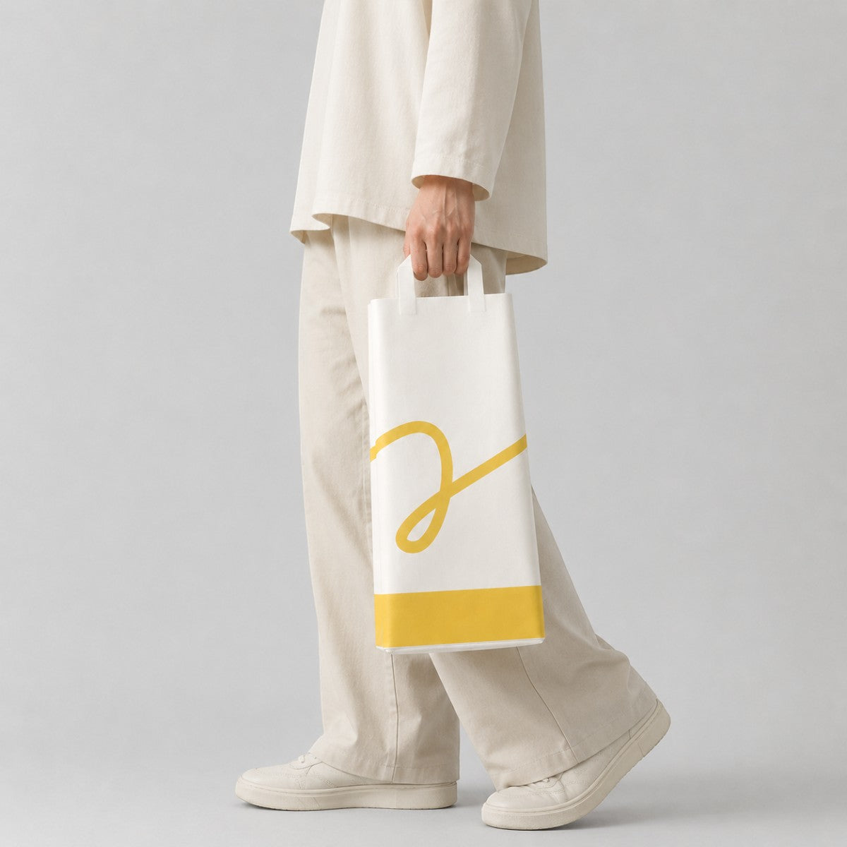 Stockka white paper gift bag with yellow accent and logo, perfect for wine or alcohol bottles.