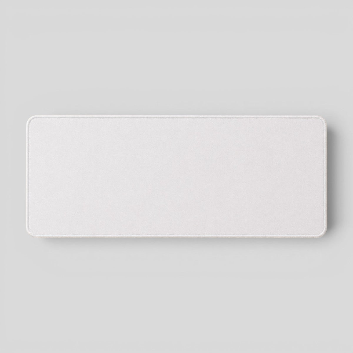 Stockka wide white desk mat with stitched edges, ideal for keyboard and mouse.