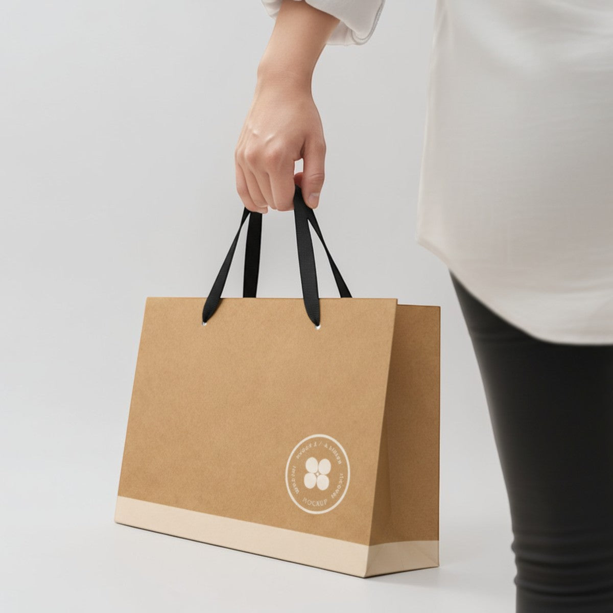 Stockka wide kraft paper gift bag with reinforced base and flat fabric handles, natural brown.
