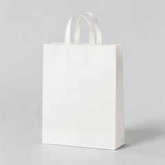 Stockka yellow recycled kraft paper shopping bag with diagonal graphic and flat handles.