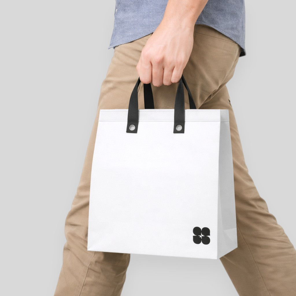 Stockker large white non-woven polypropylene tote bag with black handles and a subtle black cloverleaf logo.