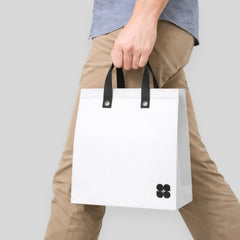 Stockker large white non-woven polypropylene tote bag with black handles and a subtle black cloverleaf logo.